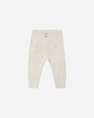 Cream ribbed knit baby pants with a buttoned waistband, shown flat on a light gray background.
