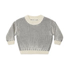 A long-sleeve knit sweater with vertical stripes in dark gray and cream, featuring solid cream ribbed trim on the crew neck, cuffs, and hem, displayed flat against a light gray background.