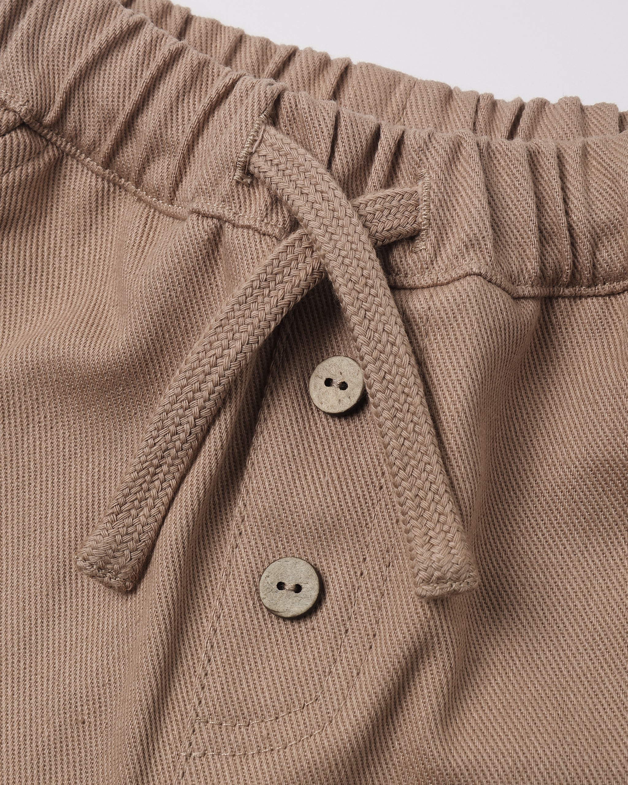 Dusty taupe-brown color with two decorative buttons.