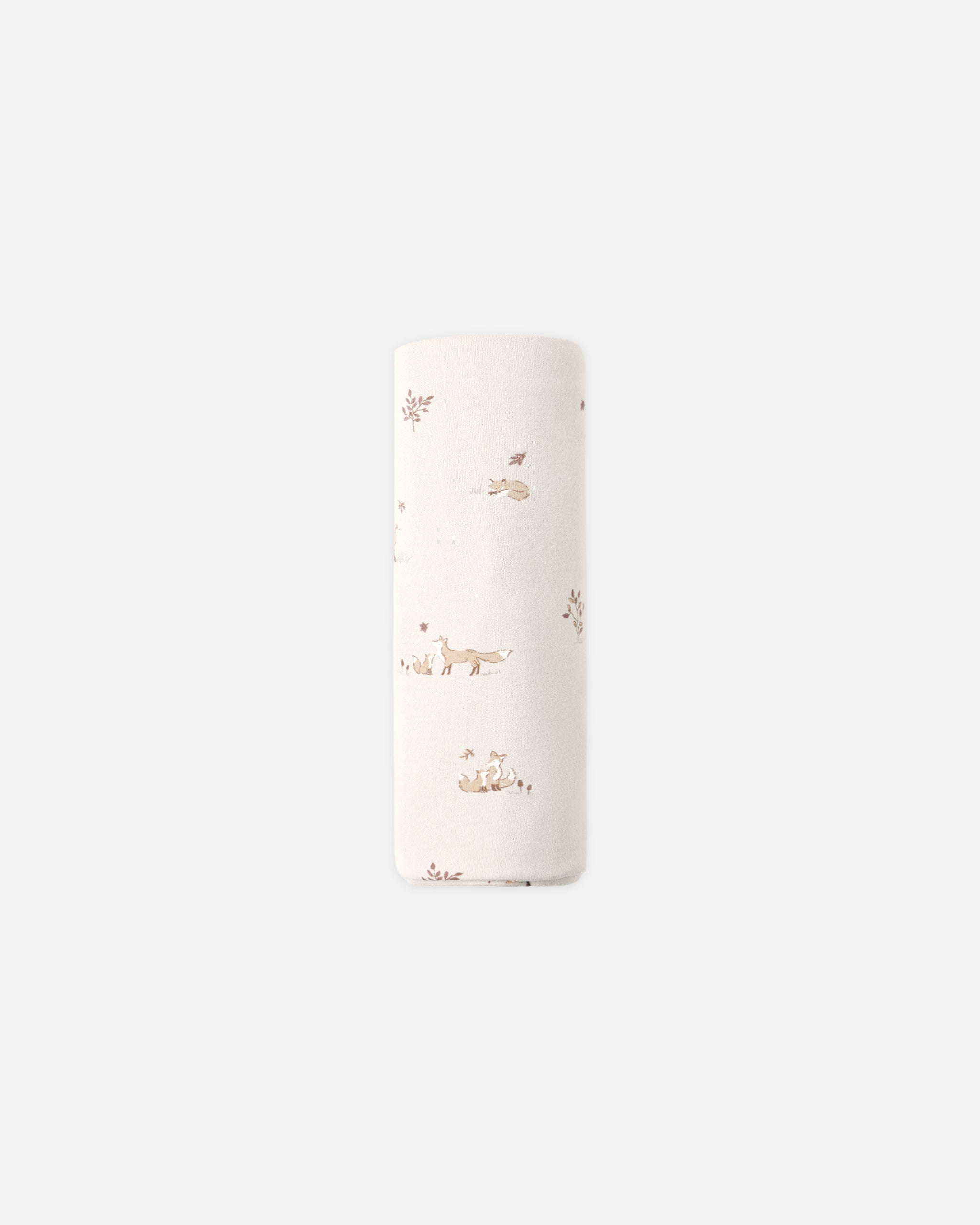 A tall, narrow cylindrical container or roll with a white surface decorated with a delicate, small-scale brown and beige woodland pattern of foxes, rabbits, and plants, set against a solid light gray background.