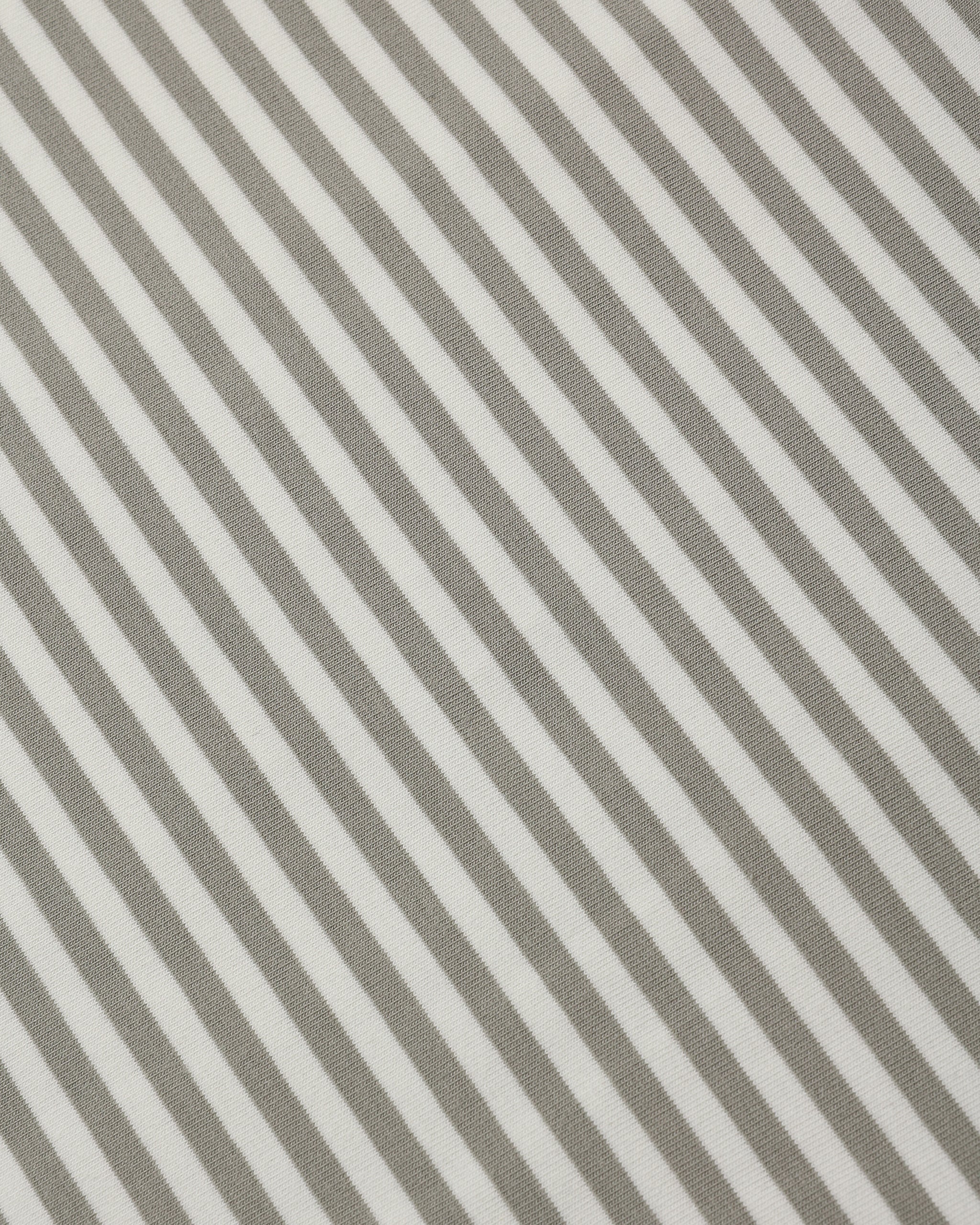 Close-up of a striped fabric pattern with alternating warm taupe-gray and off-white diagonal stripes.