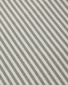 Close-up of a striped fabric pattern with alternating warm taupe-gray and off-white diagonal stripes.