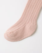 A single ribbed knit sock in a soft dusty pink color, shown against a clean white background.
