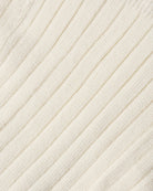 Close-up of a cream-colored ribbed knit fabric texture.