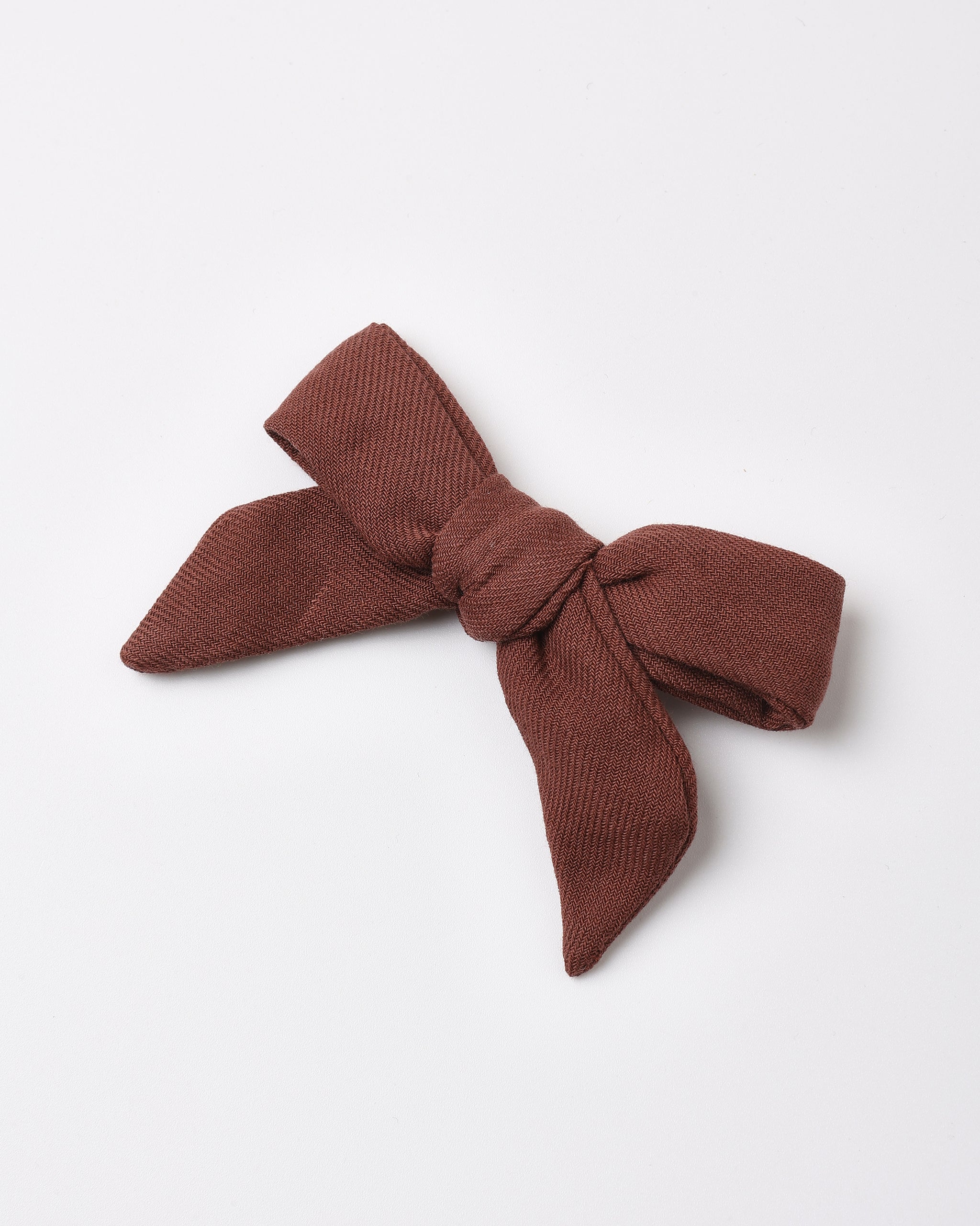 A dark brown textured fabric hair bow, styled in a knot, displayed on a clean white background.