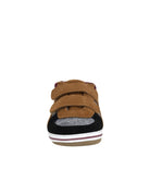 Brown children's shoe with velcro straps on a white background