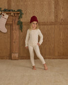 A child wearing the Rylee + Cru natural ditsy floral ribbed long-sleeve top and matching leggings paired with a dark red beanie.