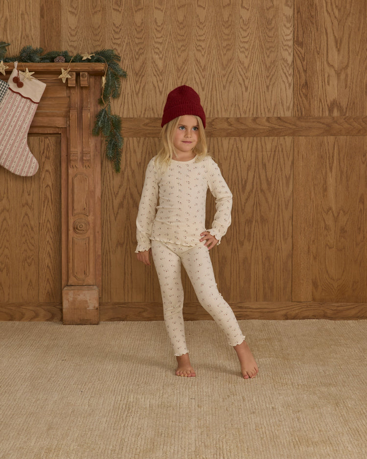 A child wearing the Rylee + Cru natural ditsy floral ribbed long-sleeve top and matching leggings paired with a dark red beanie.