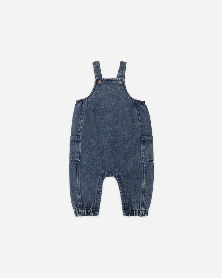 A baby's blue denim overall romper with adjustable shoulder straps and front patch pockets, shown flat on a light gray background.