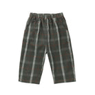 A pair of children's plaid trousers in dark green with white and red lines, featuring an elastic waistband and side pockets, shown against a plain white background.