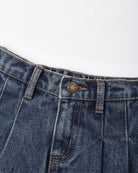 Close-up of dark blue denim jeans showing the waistband, belt loops, button closure, and front pocket stitching on a plain white background.