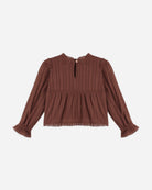 A brown long-sleeve blouse with a textured vertical ribbed knit pattern, a smocked waist, and ruffled cuffs, shown against a plain light gray background.
