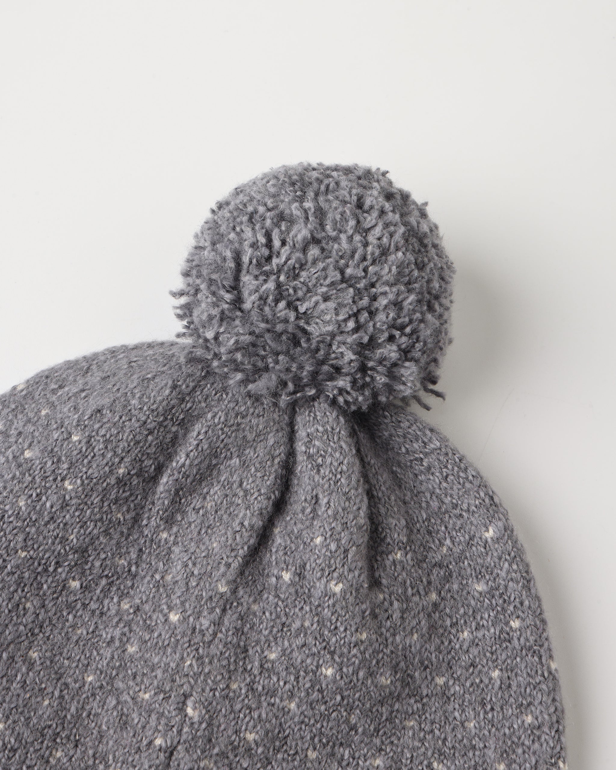 The selected item is a light blue knitted beanie hat with a ribbed cuff and a matching pom-pom on top on a white background.
