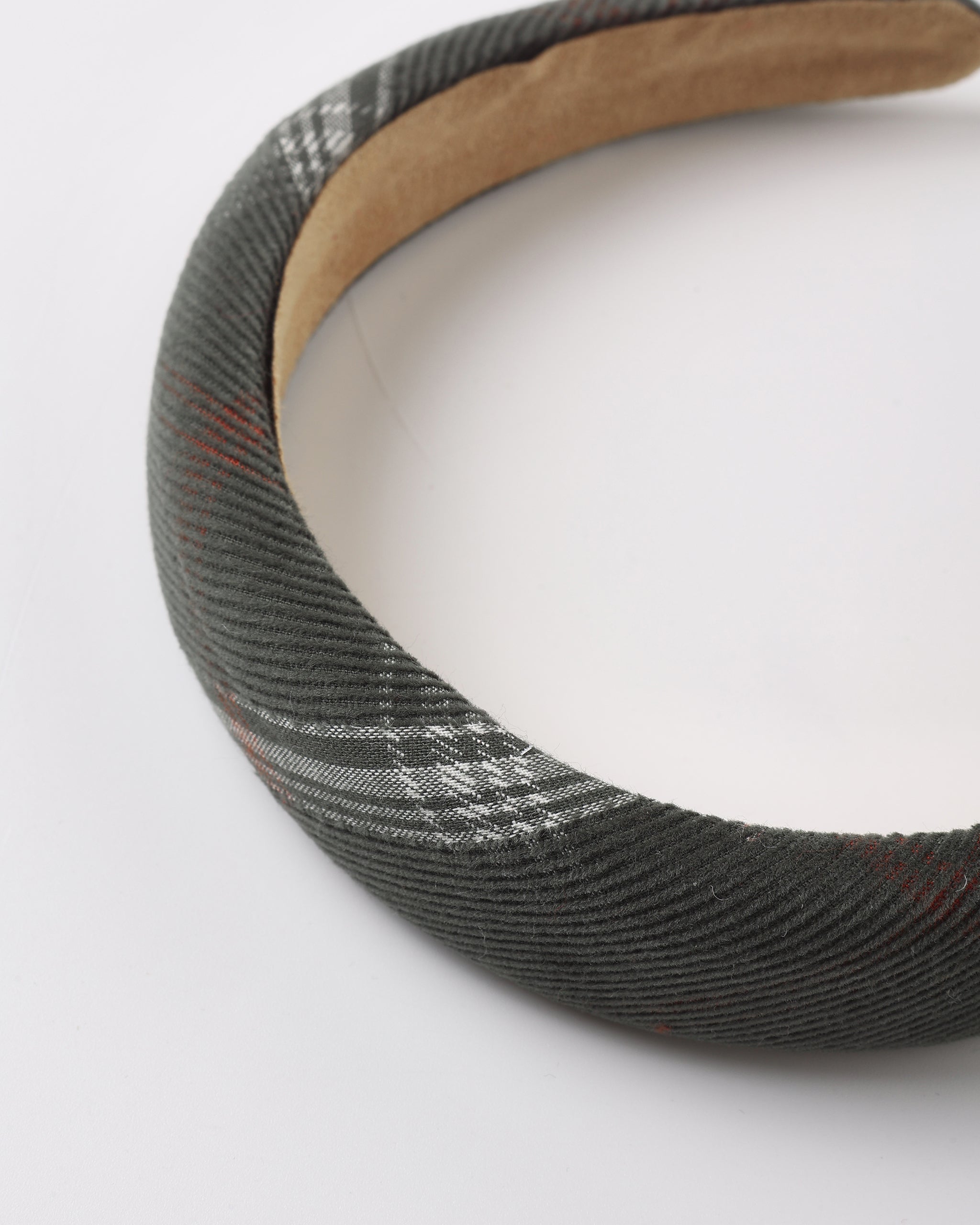 A fabric headband with a gray and white check or plaid pattern.