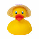 Yellow rubber duck wearing a straw hat on a white background