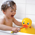 Child playing with a rubber duck in a bathtub