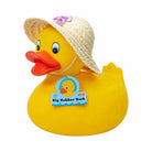 Yellow rubber duck with a straw hat and a visible brand label on a white background