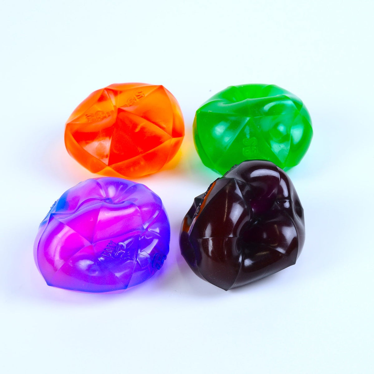 Four colorful translucent stones on a white background