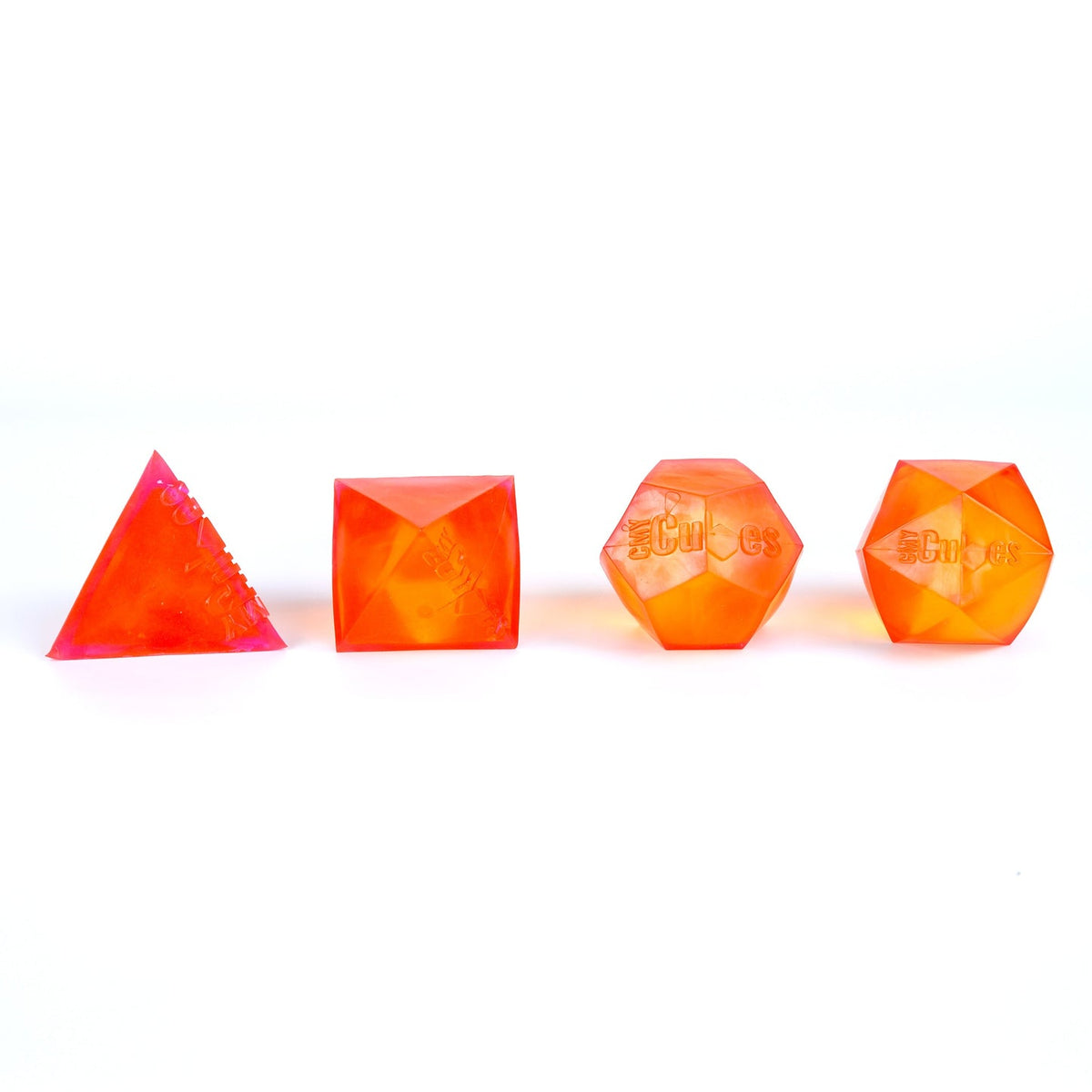 Four geometric-shaped candles in orange on a white background