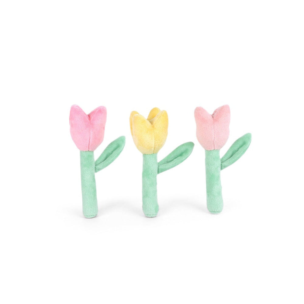 Three small plush tulip-shaped accessories arranged side by side on a plain white background. The left and right pieces are pink with mint green stems and leaves, and the center piece is yellow with a mint green stem and leaves.