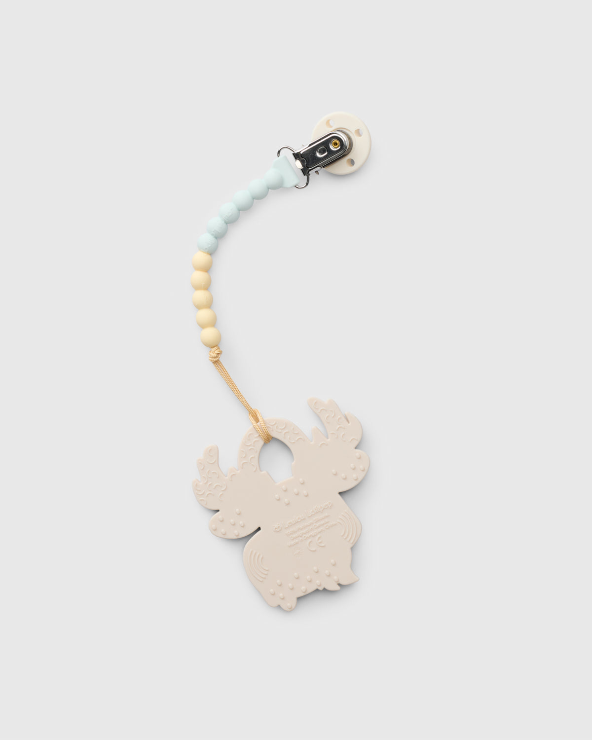 A baby teething ring clip with a light beige wooden reindeer-shaped ring, a light blue and cream beaded strap, and a black plastic clip, shown on a light gray background.