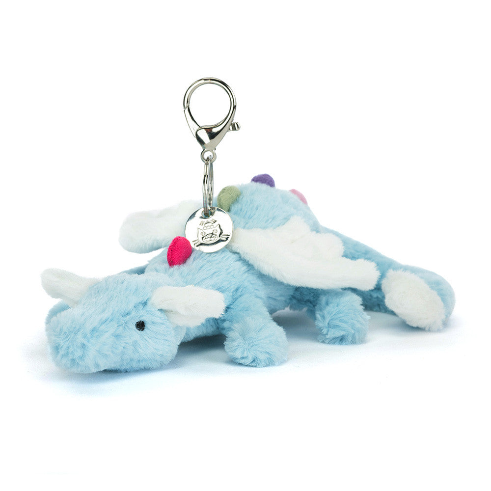 Plush dragon keychain with a tag on a white background