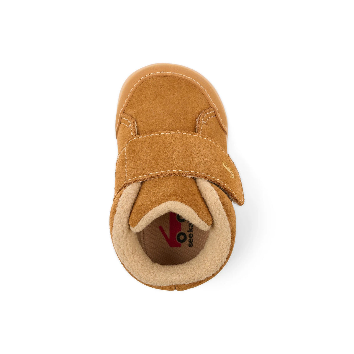 A single toddler bootie in tan suede with a hook-and-loop strap closure and a soft beige fleece lining, shown from a top-down view on a white background.