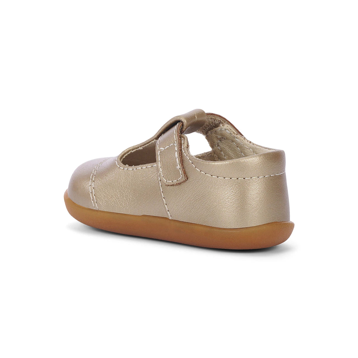Gold baby shoe with brown sole on a white background