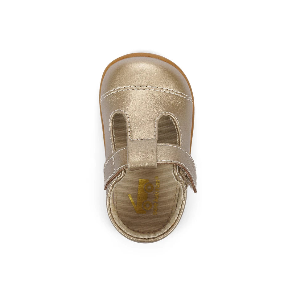 Gold children's sandal with a strap on a white background