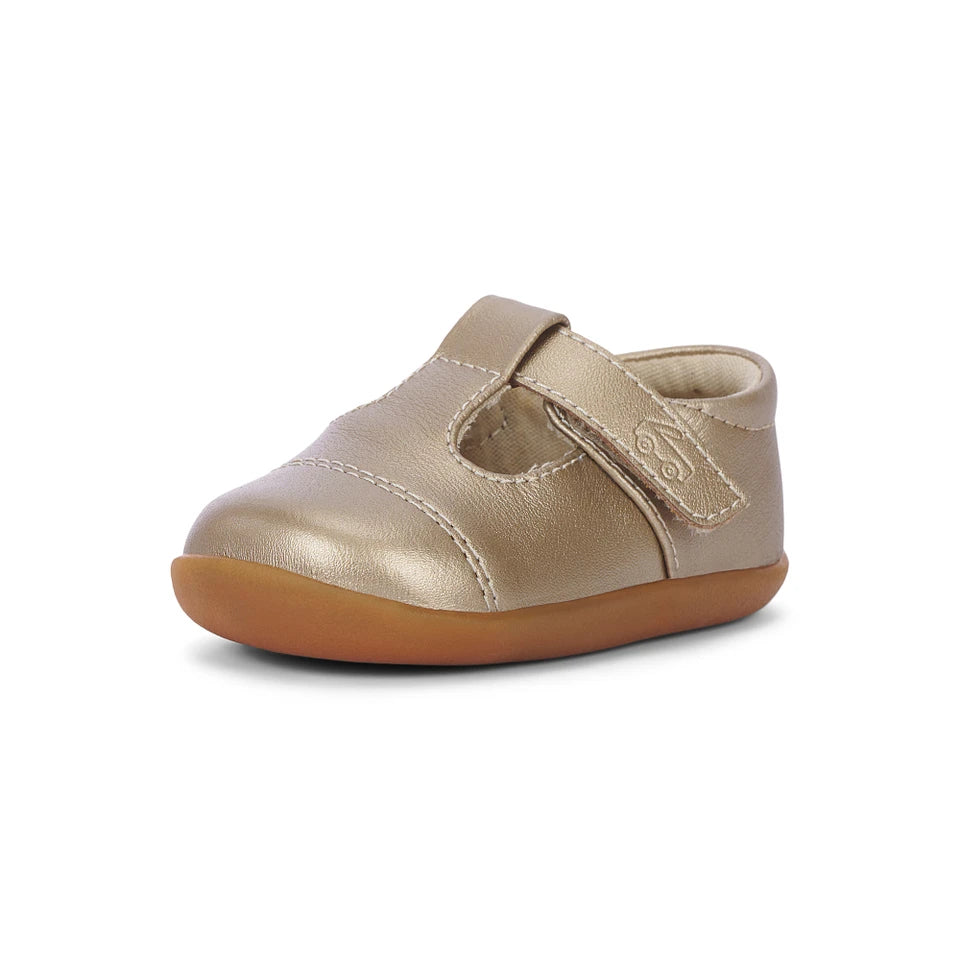 A single metallic gold baby shoe with a hook-and-loop strap and a brown gum sole, shown on a plain white background.
