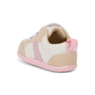 Children's shoe with beige and pink accents on a white background