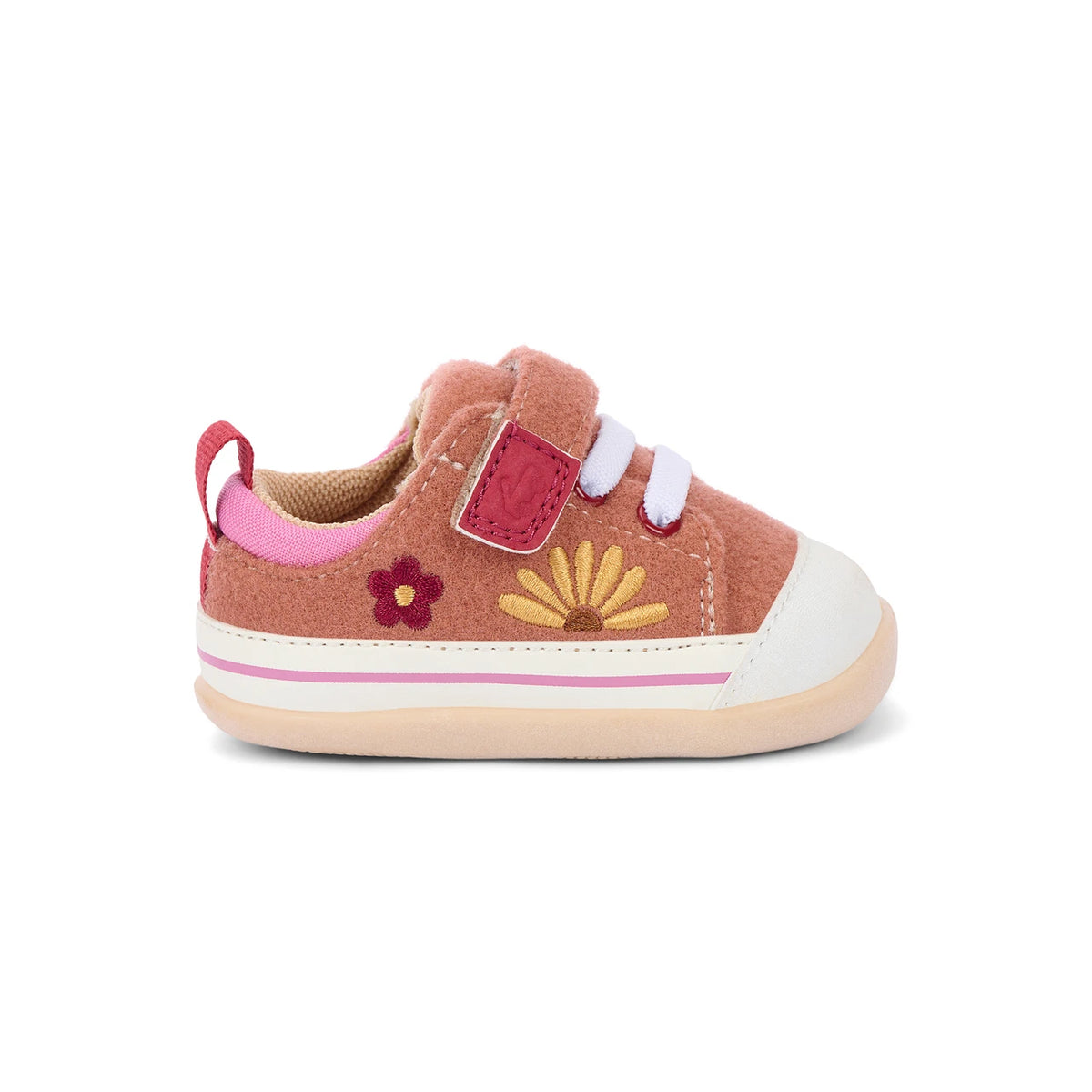 A toddler's pink suede sneaker with a white rubber toe cap and sole, featuring a pink pull tab, hook-and-loop strap closure, embroidered pink and yellow flowers, and a thin pink stripe on the side.