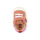 A single baby shoe shown from a top-down view on a white background. The shoe features a dusty rose-brown suede upper with two white hook-and-loop straps, a pink pull tab, a beige fabric footbed, and a white rubber toe cap.