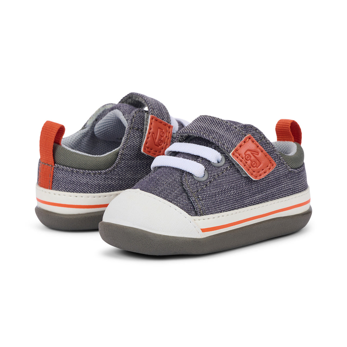 Pair of children's shoes with gray, orange, and white design on a white background