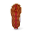 Close-up of a shoe sole with red and brown pattern on a white background