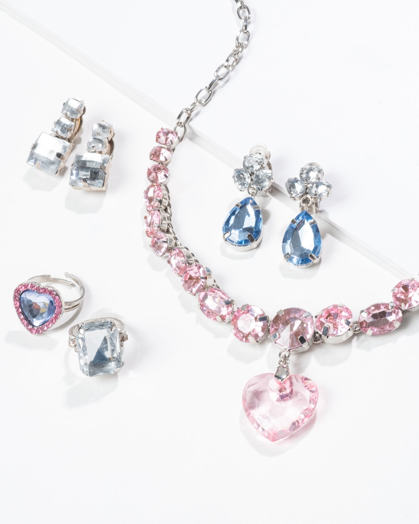 Jewelry set with pink and blue crystals on a white background