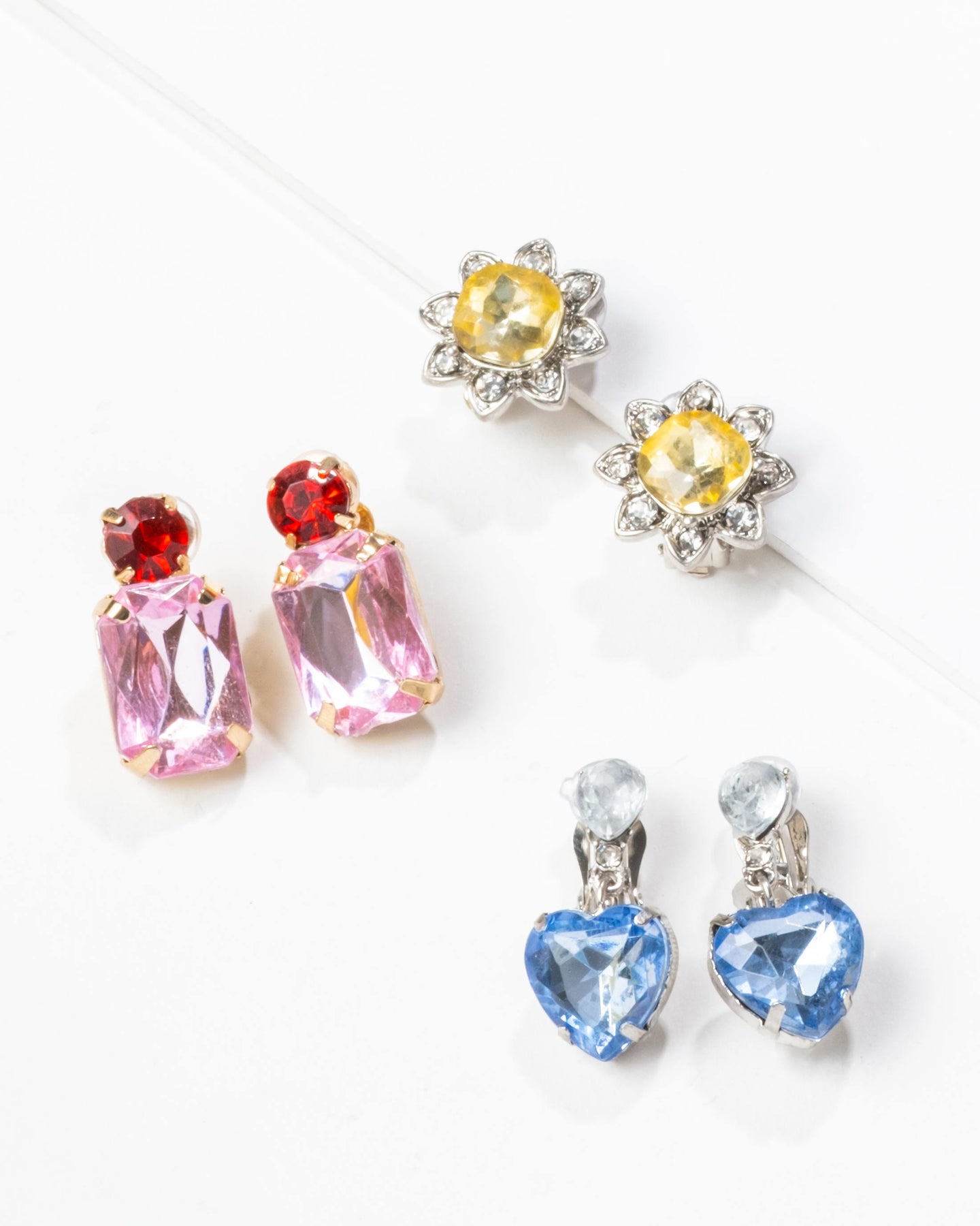 Set of colorful gemstone earrings on a white background