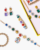 Colorful gemstone jewelry set including earrings and bracelet on a white background