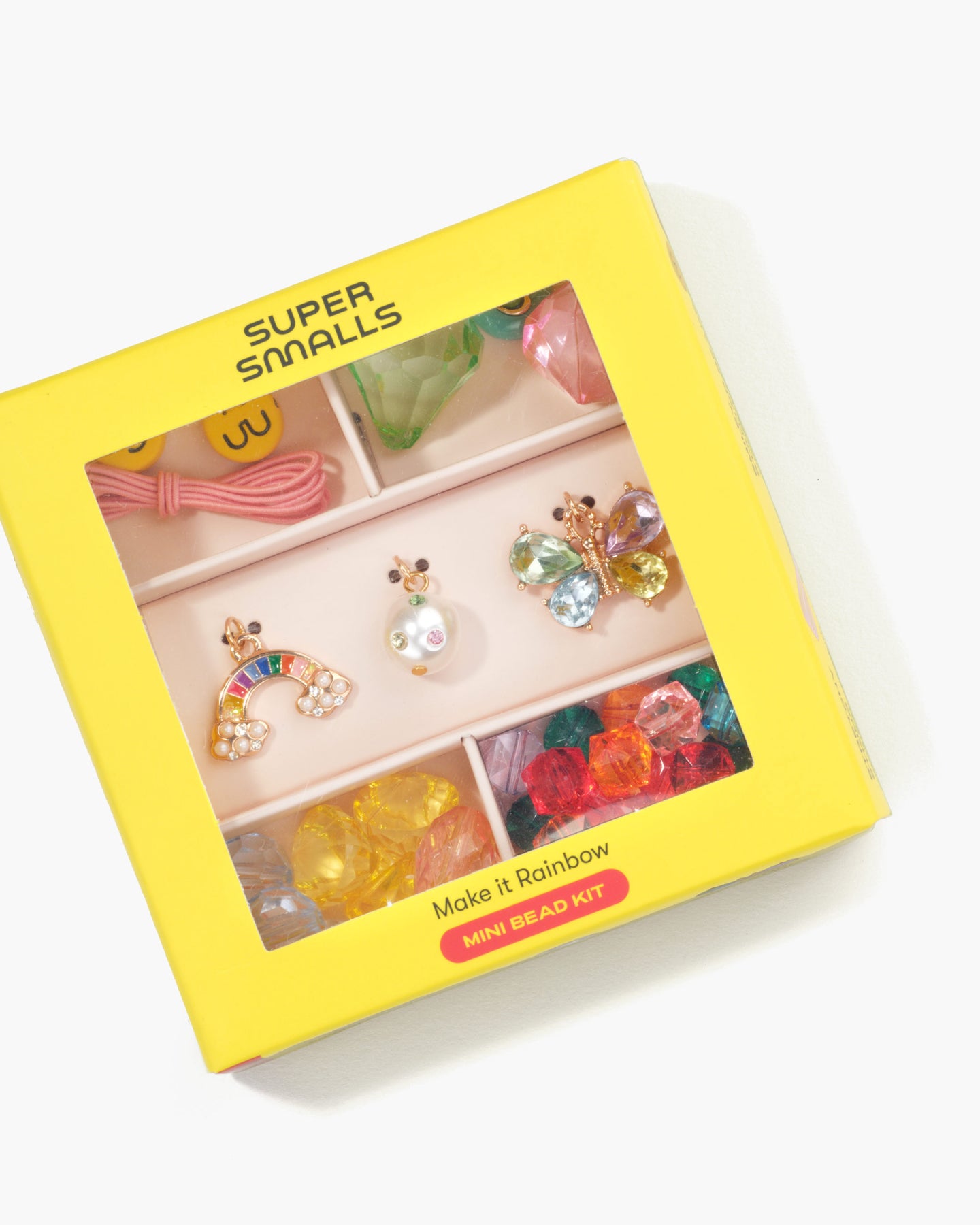 Yellow box of Super Smalls mini bead kit with colorful beads and accessories on a white background