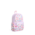 A light pink backpack with a colorful sprinkle pattern, featuring a top handle, main zippered compartment, and a front zippered pocket. The brand name 'KIKIKIK' is visible on the upper right side of the bag.
