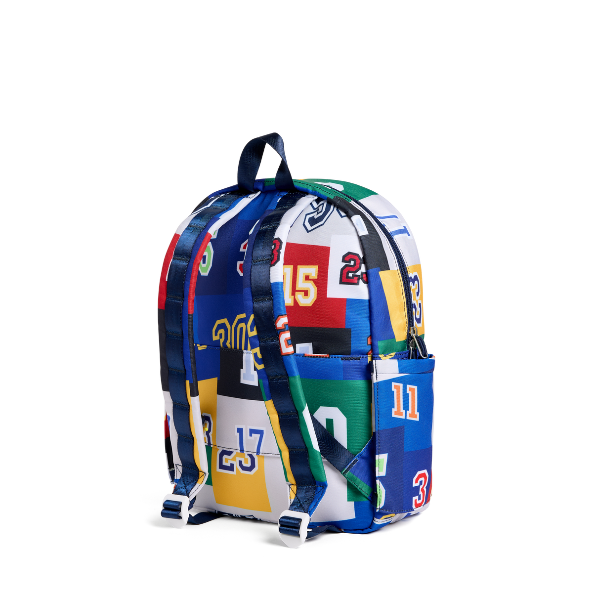 A backpack featuring a vibrant collage print of various sports jerseys in blue, white, red, yellow, and green, with matching blue shoulder straps, shown against a plain white background.