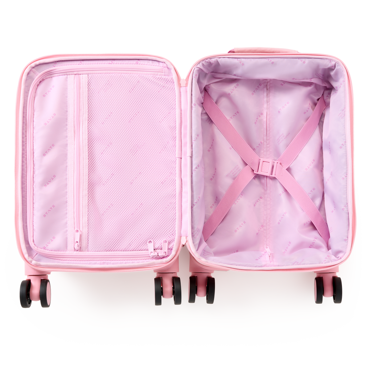 Open view of a pink State Bags Mini Logan carry-on suitcase, revealing light pink interior lining with elastic compression straps and a zippered mesh compartment, set against a transparent background.