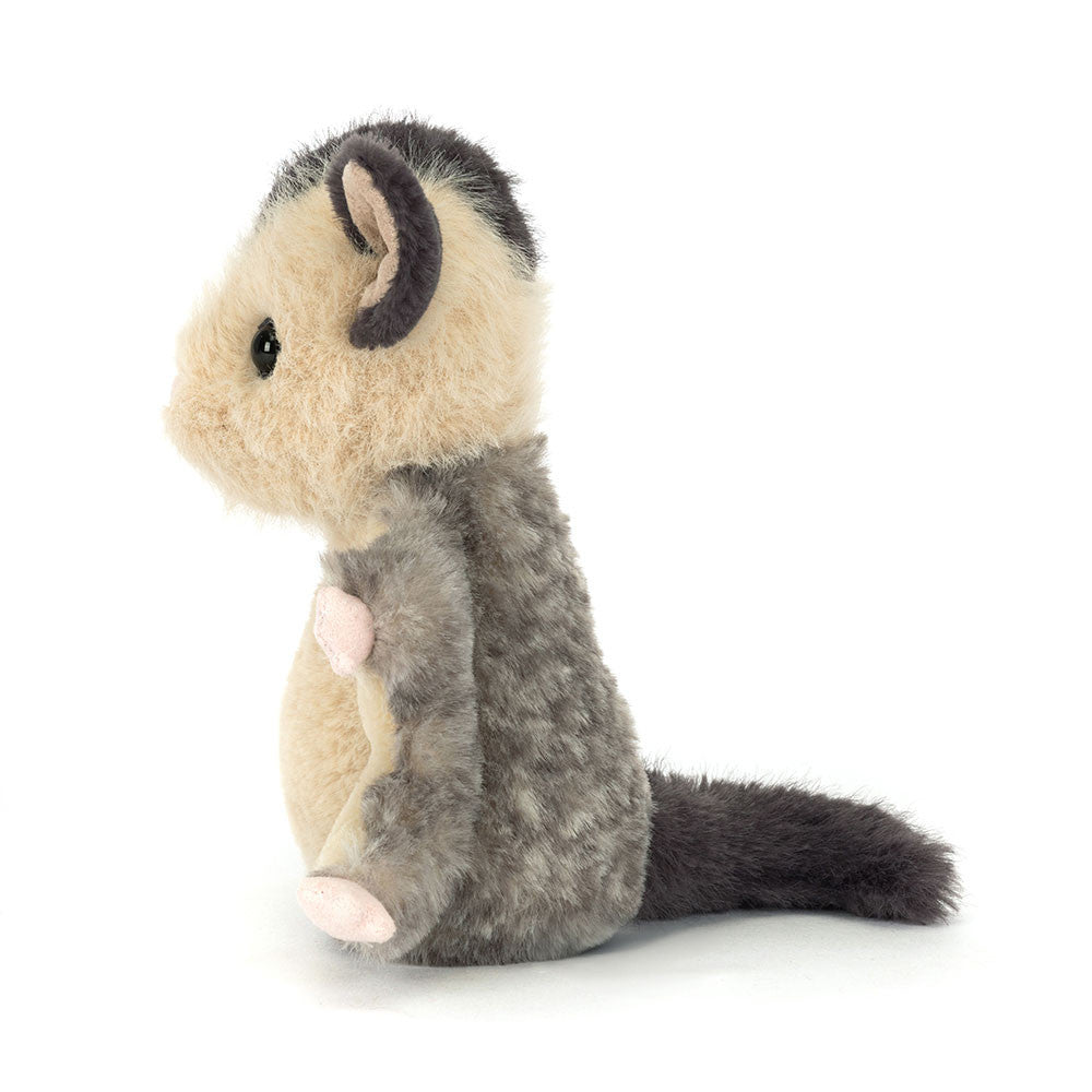 Plush toy possum on a white background
