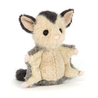 Plush toy resembling a possum on a white background