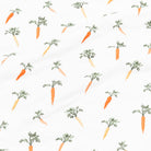 Pattern of orange carrots with green tops on a white background