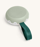 Portable speaker with a green handle on a white background