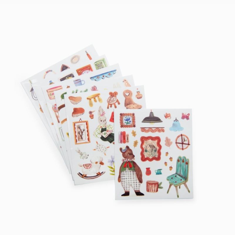 Two sheets of decorative stickers with various illustrations on a white background