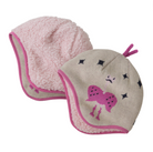 A reversible baby beanie with one side showing a sweater-knit pattern in a beige color and the other side displaying a high-pile fleece in pink. Decorative elements include small stars and what appears to be a cute animal face.