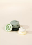 Set of small ceramic pots on a beige background
