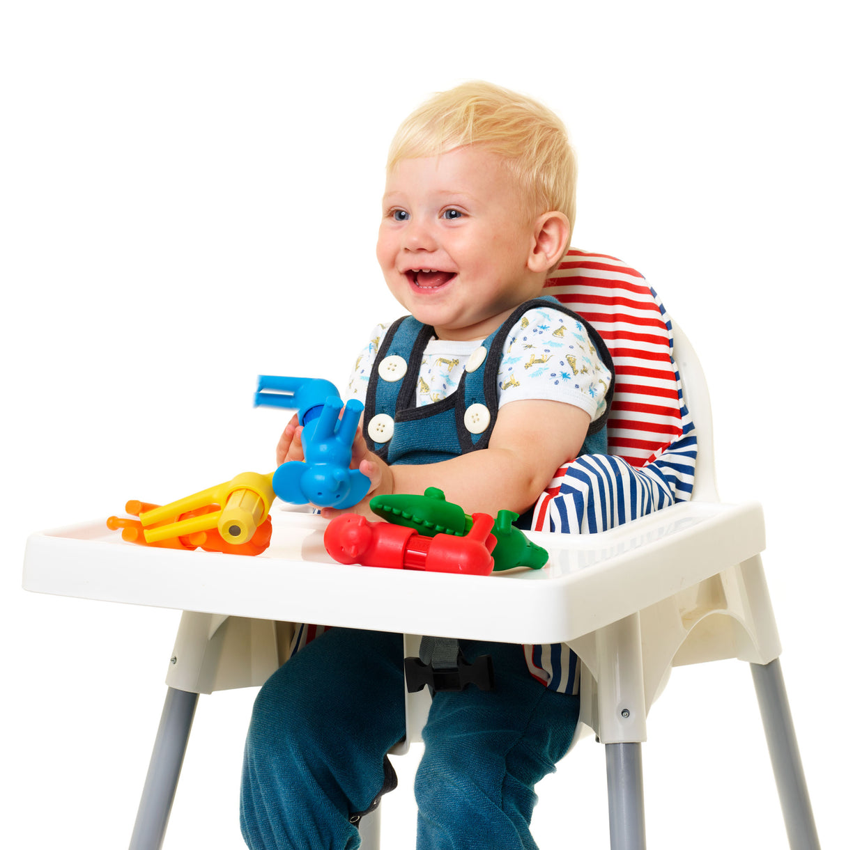 Child playing with colorful toys in a high chair on a white background